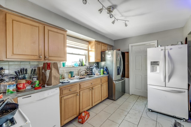 kitchen featuring sink, white appliances, decorative backsplash, light brown cabinetry, and light tile patterned floors