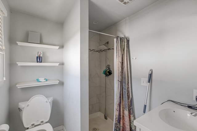 bathroom featuring vanity, curtained shower, and toilet