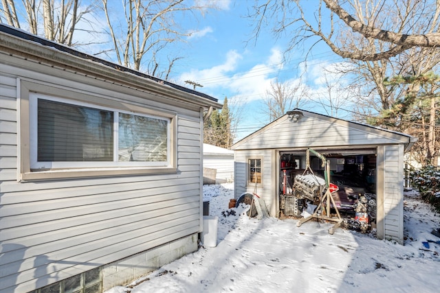 view of snowy exterior with an outbuilding