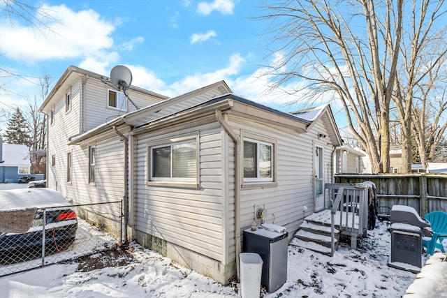 view of snow covered exterior featuring a wooden deck