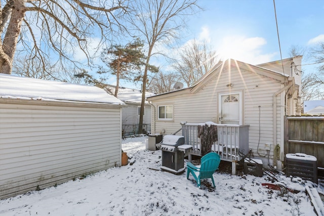 snow covered rear of property featuring central air condition unit