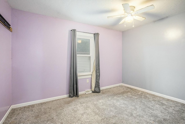 carpeted spare room with ceiling fan