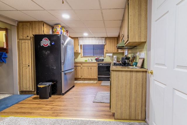 kitchen featuring light wood-type flooring, stainless steel fridge, sink, dishwasher, and a drop ceiling