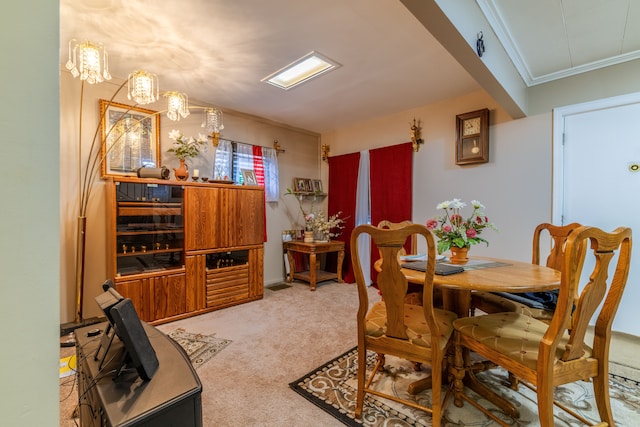 dining room featuring crown molding and carpet floors