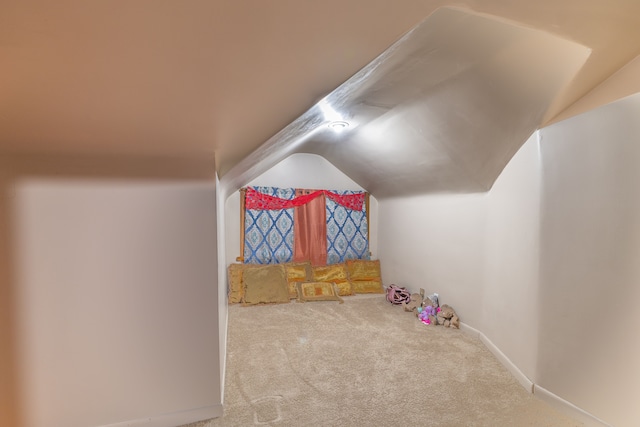 bonus room featuring lofted ceiling and light colored carpet