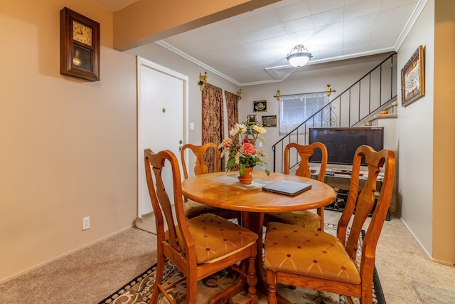 dining room featuring crown molding and carpet floors