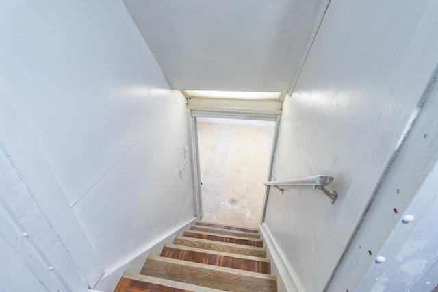 staircase with hardwood / wood-style floors