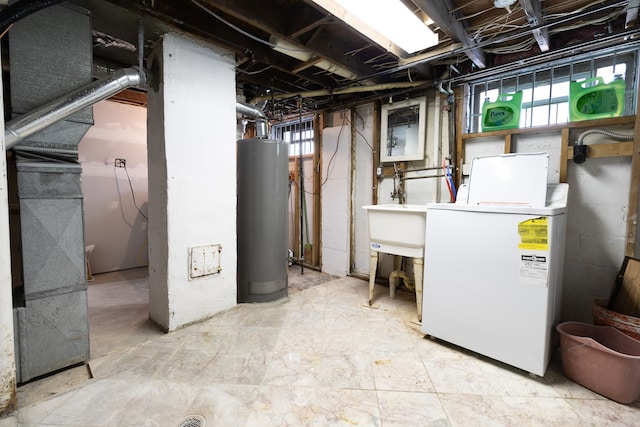 basement with water heater and washer / dryer