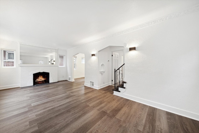 unfurnished living room featuring a fireplace and hardwood / wood-style floors