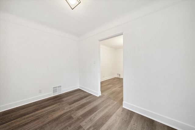 unfurnished room with hardwood / wood-style flooring