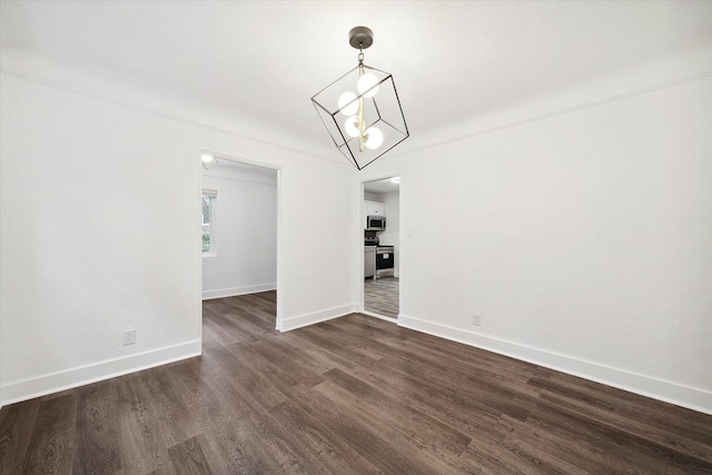 unfurnished living room with dark hardwood / wood-style flooring and an inviting chandelier