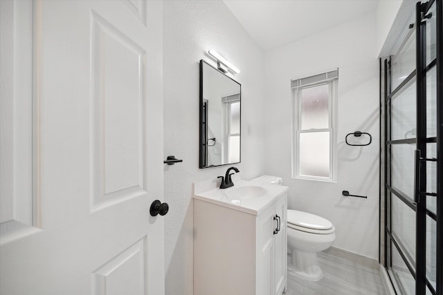 bathroom featuring vanity, hardwood / wood-style flooring, and toilet