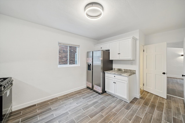 kitchen featuring light hardwood / wood-style flooring, white cabinets, and stainless steel appliances