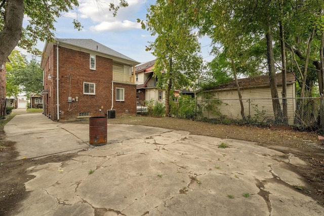 back of property featuring central AC unit and a patio area