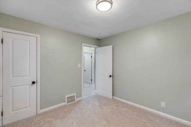 unfurnished bedroom featuring light colored carpet