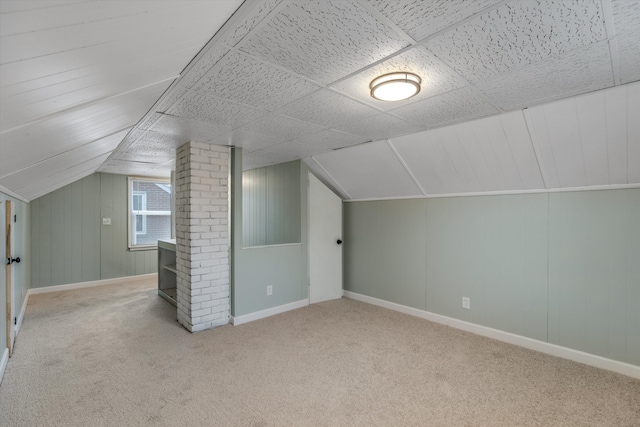 additional living space with light carpet and lofted ceiling