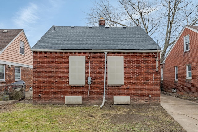 rear view of property with a lawn