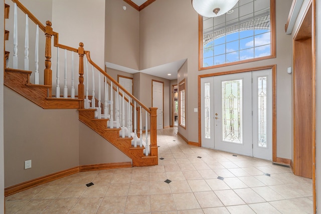 tiled foyer entrance with a high ceiling