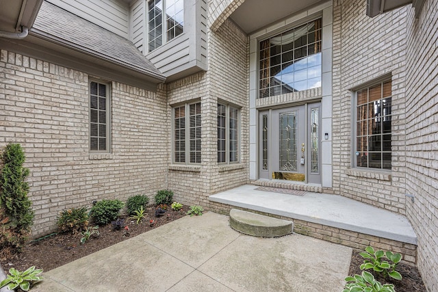 view of exterior entry featuring a patio