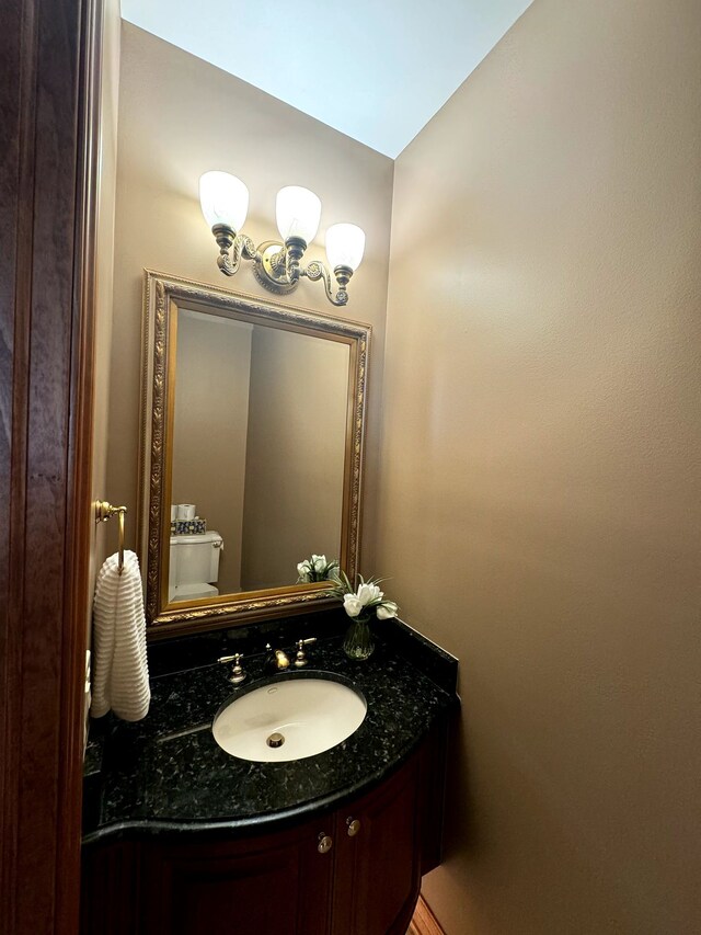 bathroom featuring vanity and toilet