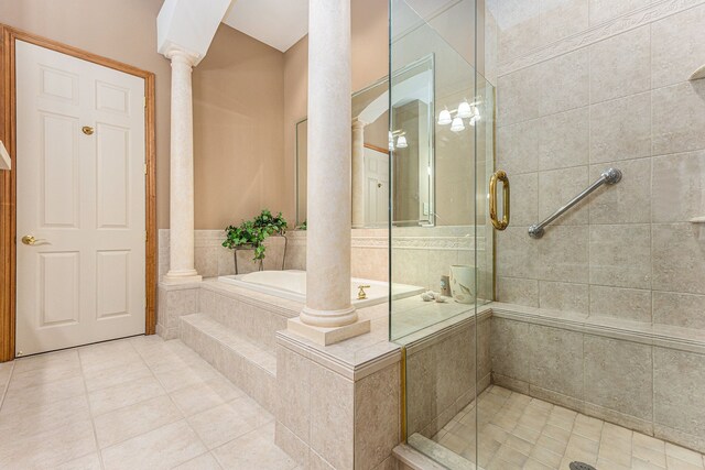 bathroom with tile patterned flooring, decorative columns, and separate shower and tub