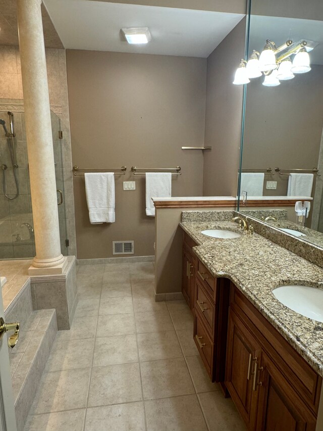 bathroom with walk in shower, vanity, decorative columns, and tile patterned floors