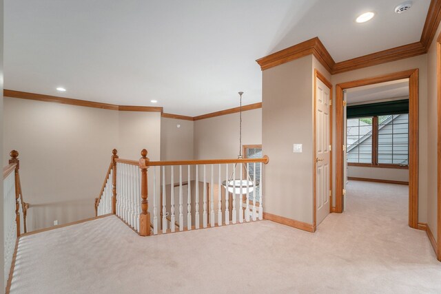 hallway with light colored carpet and crown molding