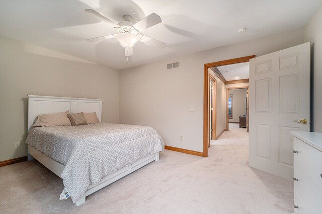 carpeted bedroom featuring ceiling fan and ornamental molding