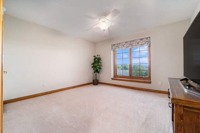 unfurnished bedroom with ceiling fan and light colored carpet