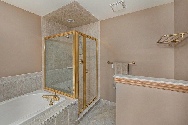 bathroom with shower with separate bathtub and tile patterned floors