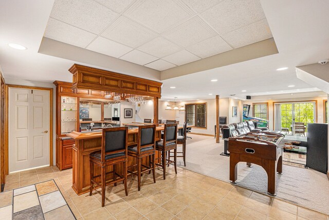 interior space featuring light carpet and a breakfast bar