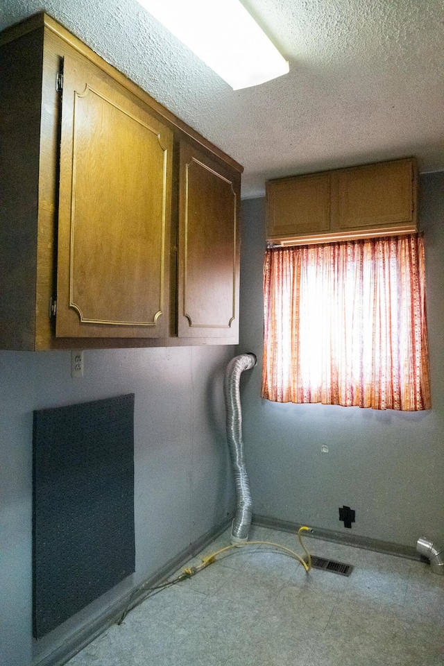 laundry room with a textured ceiling