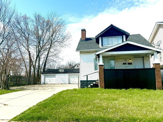 view of property exterior with a yard, an outbuilding, and a garage