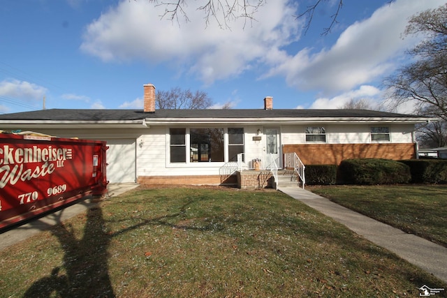 rear view of property with a lawn