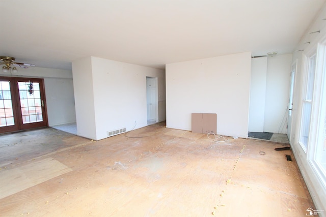 unfurnished room featuring ceiling fan and french doors