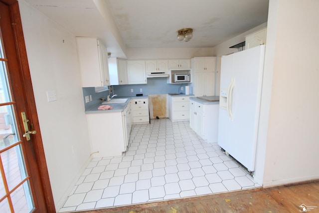 kitchen featuring white cabinets, white appliances, and sink