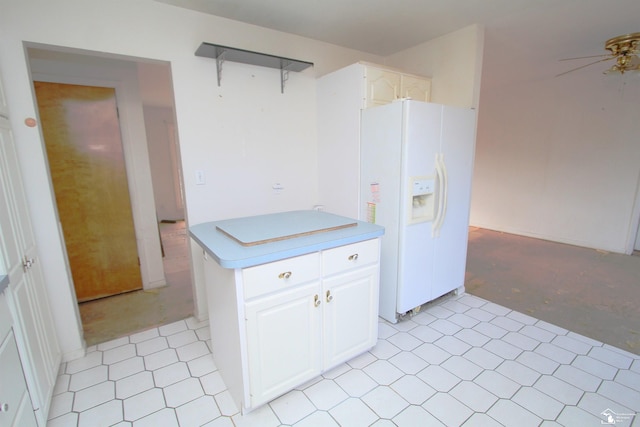 kitchen with white refrigerator with ice dispenser, white cabinetry, and ceiling fan