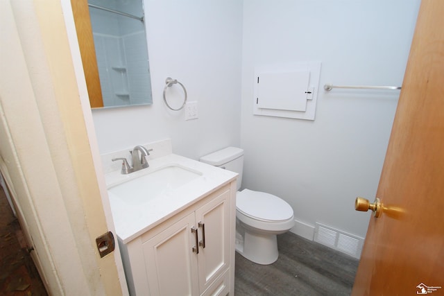 bathroom featuring toilet, vanity, and hardwood / wood-style flooring