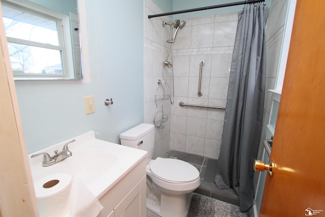 bathroom with vanity, toilet, and curtained shower