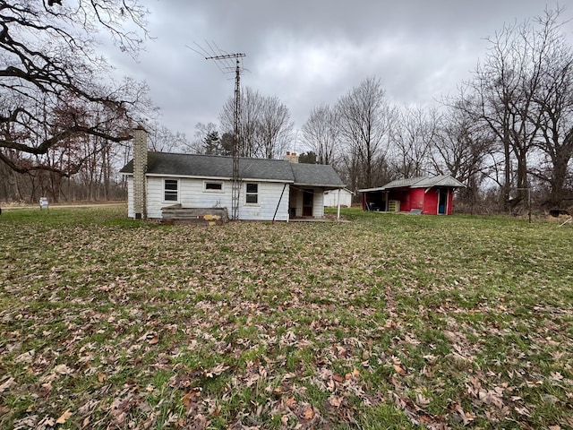 back of property featuring a lawn