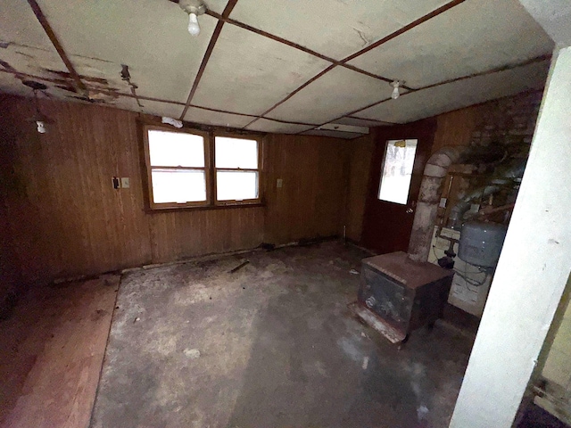 basement featuring wooden walls