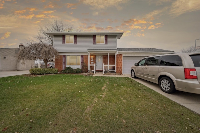 front facade featuring a lawn, a porch, and a garage