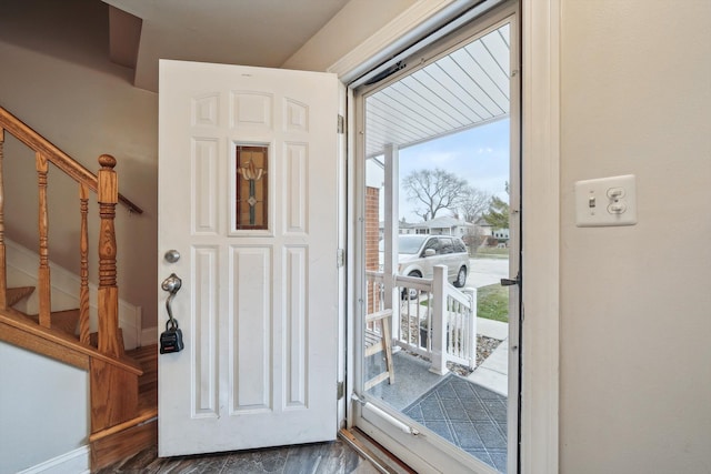 doorway to outside featuring dark wood-type flooring