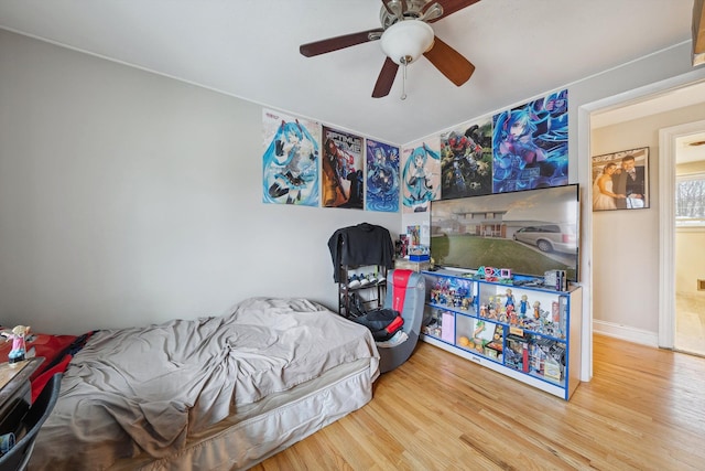 bedroom with ceiling fan and wood-type flooring