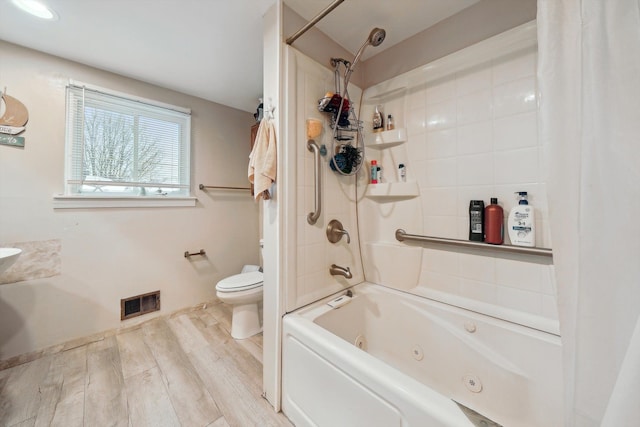 bathroom with shower / bathtub combination with curtain, toilet, and wood-type flooring