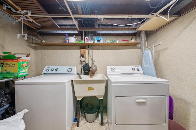 washroom featuring independent washer and dryer and sink