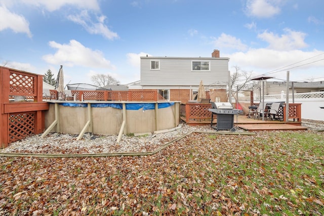 back of property featuring a swimming pool side deck