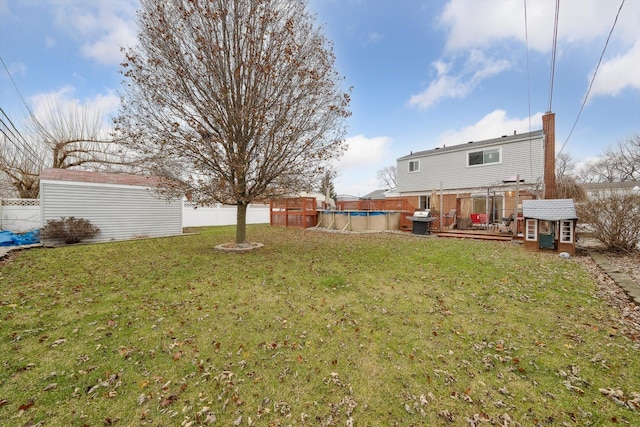 view of yard with a swimming pool side deck