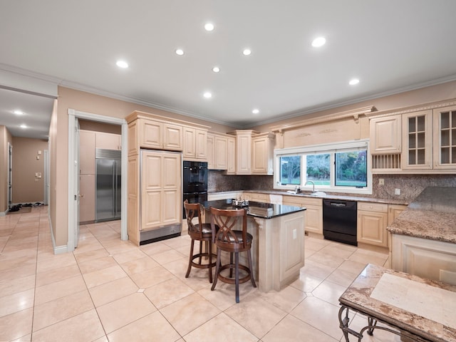 kitchen featuring dark stone counters, black appliances, sink, tasteful backsplash, and a kitchen island