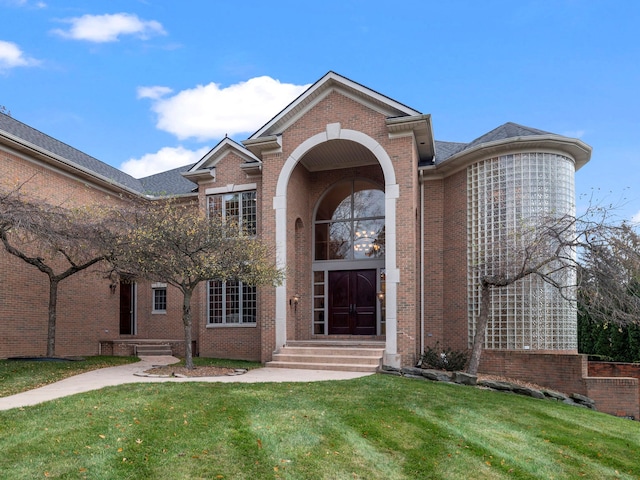 view of exterior entry with a yard